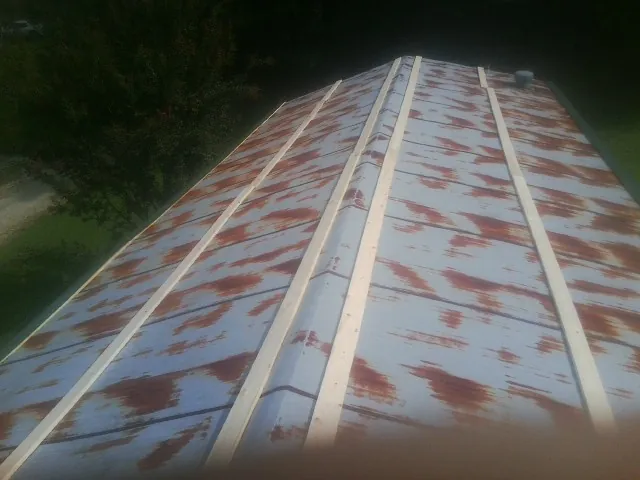 Rusted metal roof panels with new wood purlins before replacement — Storm Damage Roof Repair in Cedarville by Roofing Brothers