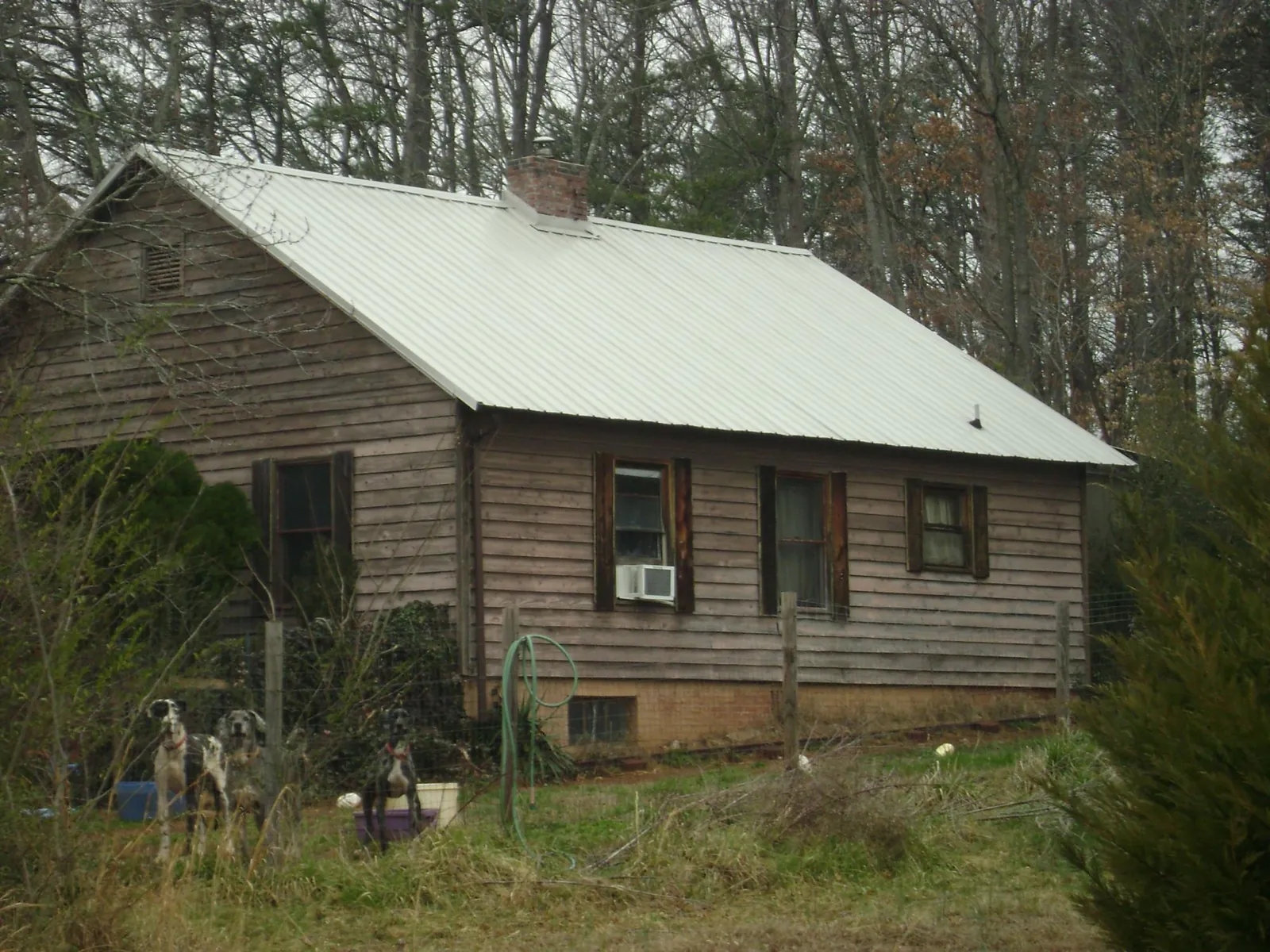 White metal roof on an old wood sided farmhouse, from a Metal Roof Installation job in Cedarville